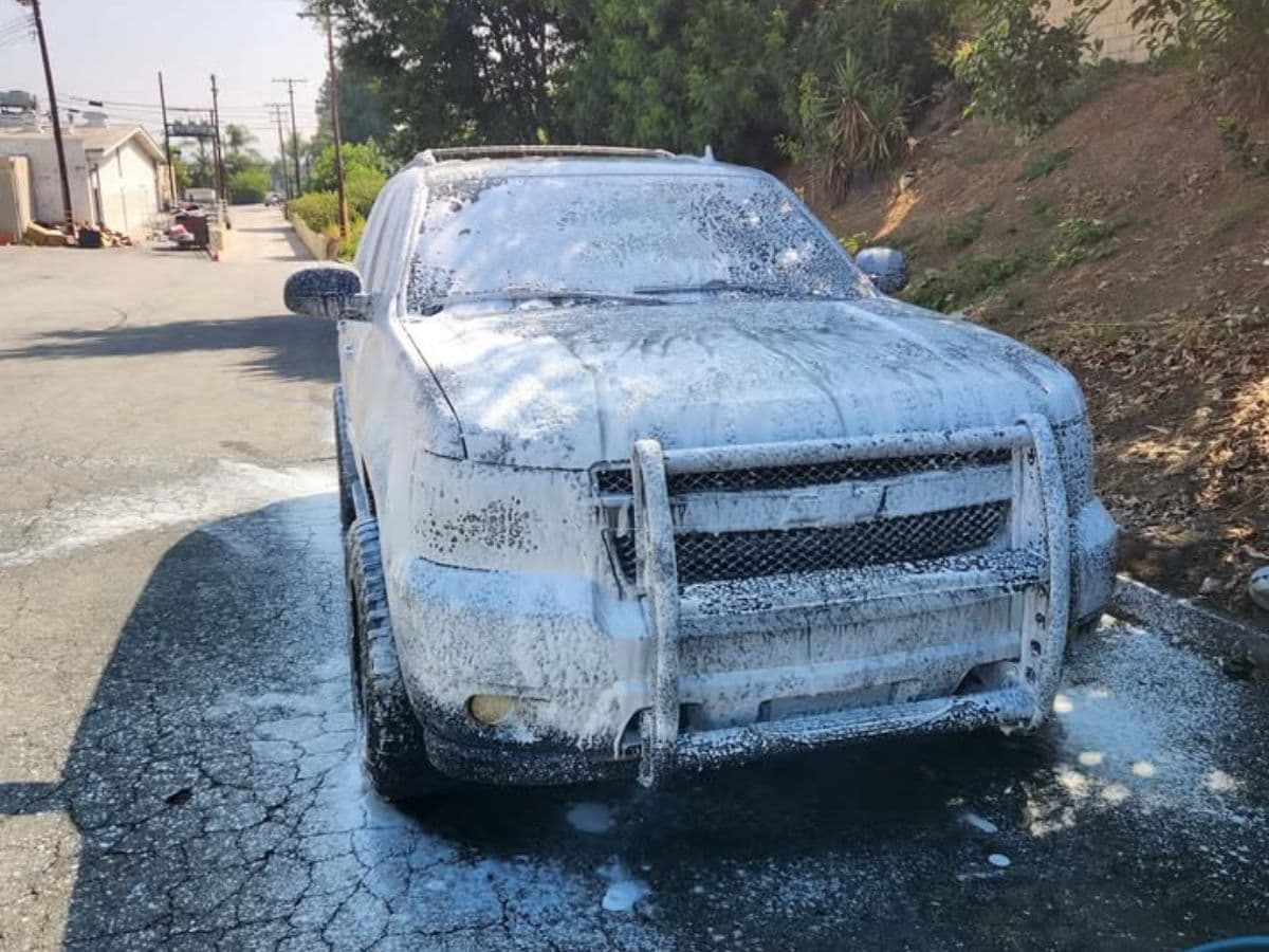 Rafael hand-washing a car at a customer's home